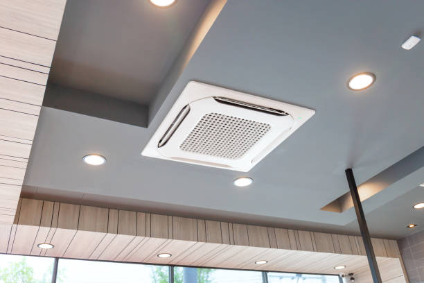 Modern ceiling mounted cassette type air conditioning system in coffee shop Modern ceiling mounted cassette type air conditioning system in coffee shop ceiling stock pictures, royalty-free photos & images