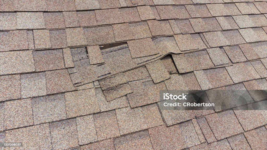 damaged roof shingles Roof Shingles damaged and in need of repair Rooftop Stock Photo