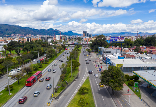 View from a drone of the highway in the city of Bogotá where you can see public transport buses called transmilenio with car traffic around. Bogota Colombia. July 26, 2021