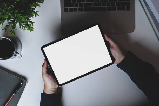 istock Above view man holding digital tablet with blank screen. 1331215397
