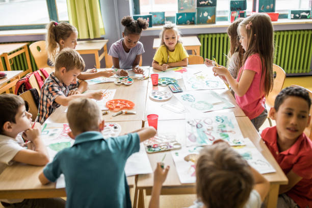 istock Large group of elementary students having an art class in the classroom. 1331216237