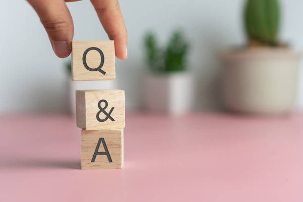 istock Q and A alphabet on wooden cube in hand hold with background. Question and answer meaning concept. 1331217020