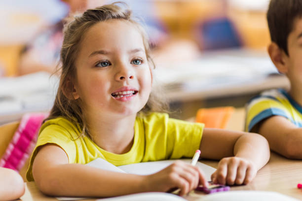 istock Happy schoolgirl paying attention on a class at elementary school. 1331217106