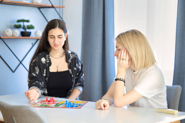 istock Lesbian Couple Playing Board Game at Home 1331218326