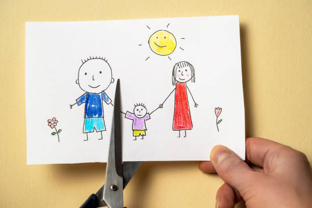 istock Child's drawing, which depicts mom, dad and child, is cut with scissors. 1331219711