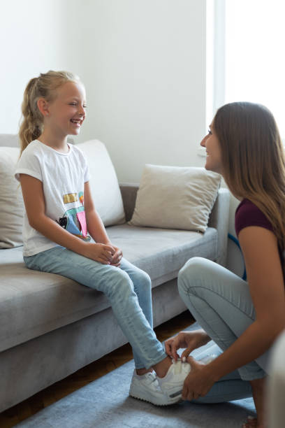 istock Mother tying her daughter shoelaces 1331221348