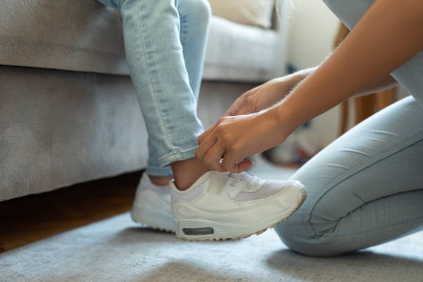 istock Mother helping her daughter tying the shoelace 1331221410