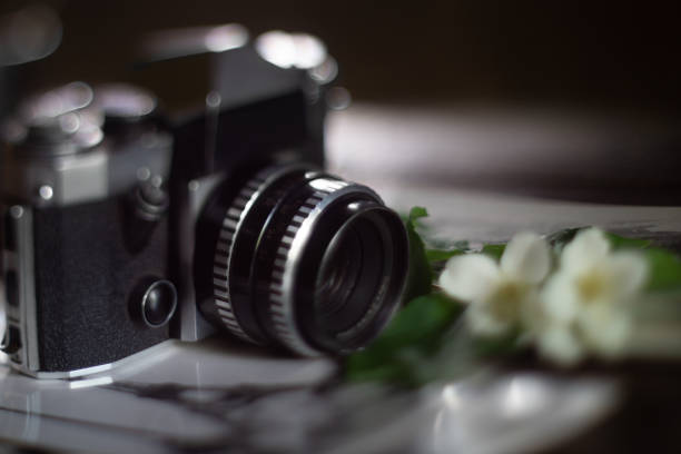 istock Old outdated camera and black and white photo in retro style 1331229568