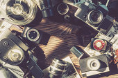 Old outdated movie cameras, photo cameras, lenses and exposure meters