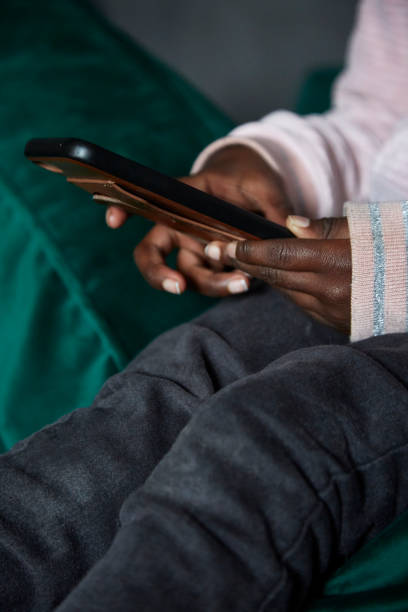 istock Closeup of black child's hands on mobile device 1331235509