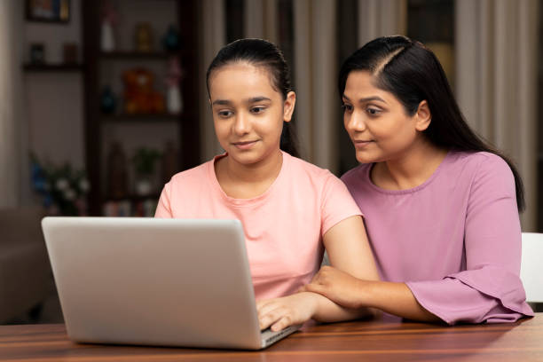 istock shot of a mother and daughter using laptop at home 1331237507