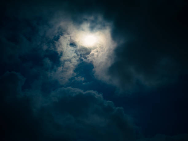 Full moon breaking through dark clouds