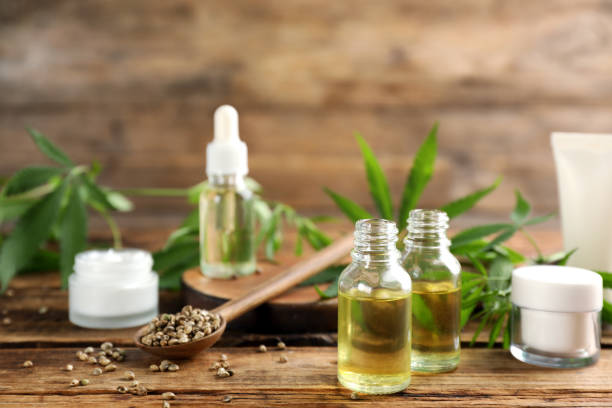 istock Composition with CBD oil, THC tincture and hemp leaves on wooden table 1331240371