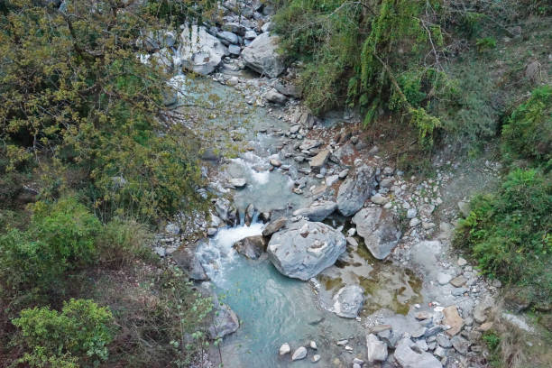 Creek with mountain range and cloudy blue sky