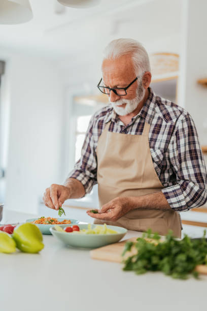 istock Nutritionist cooking at home and preparing salad 1331243063