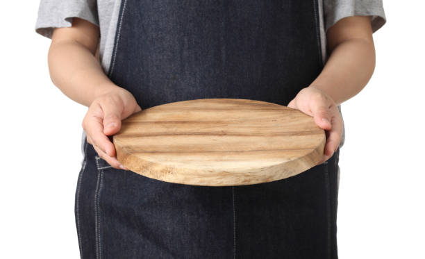 Chef holding wooden cutting board isolated on white background stock photo