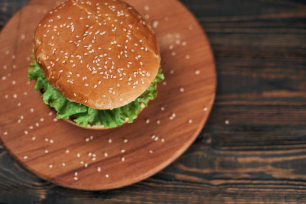 istock delicious burger on a wooden chopping board 1331246994