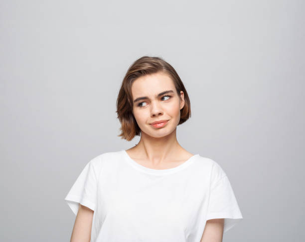 istock Thoughful young woman in white t-shirt 1331249691