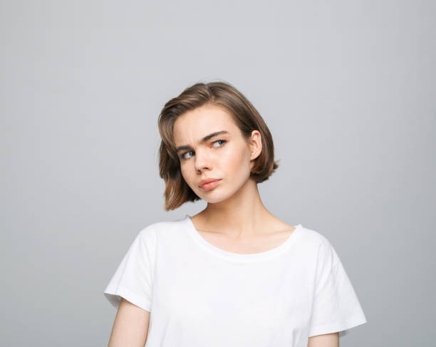 istock Thoughful young woman in white t-shirt 1331249731