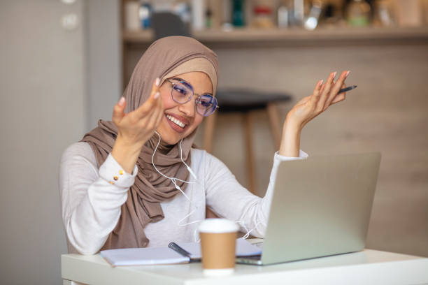 istock Young woman having video call on laptop computer at home 1331252220