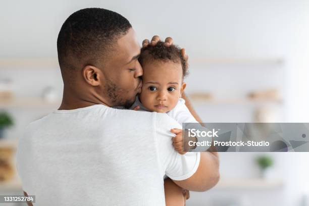 Fathers Care Young Black Dad Holding And Kissing Adorable Newborn Baby Stock Photo - Download Image Now