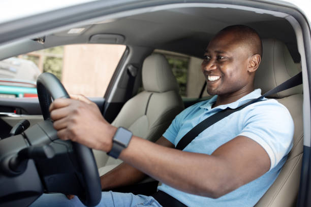 istock Handsome black man driving car, shot from outside 1331254835