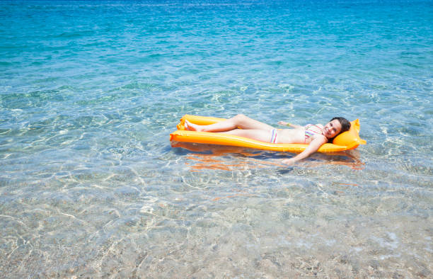istock Woman relaxing on beautiful beach with turquoise water 1331255676