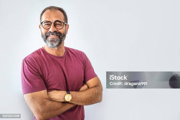 Portrait Of Happy Mature Man Wearing Spectacles And Looking At Camera Indoor Stock Photo - Download Image Now