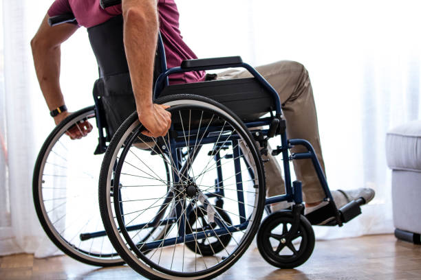 istock Unrecognizable disabled man sitting in a wheelchair. 1331257497