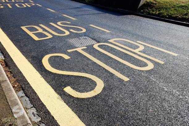 istock Bus stop sign painted on tarmac road surface 1331260359
