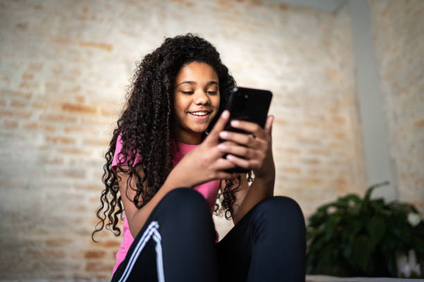 istock Girl texting on smartphone at home 1331262103