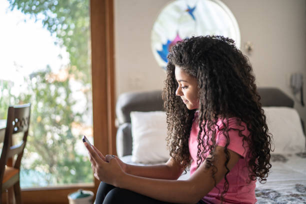 istock Girl taking a selfie or doing a vide call on smartphone at home 1331262114