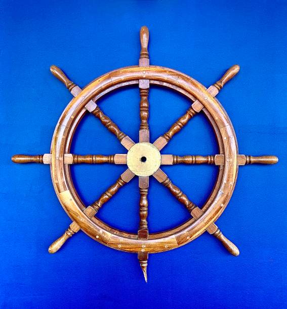 istock Wooden Ships Wheel against Blue Wall 1331263366