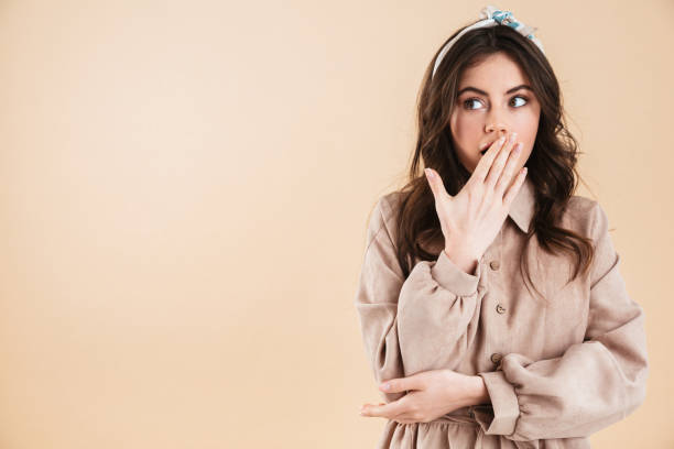istock Shocked young woman posing isolated over beige wall background. 1331263833