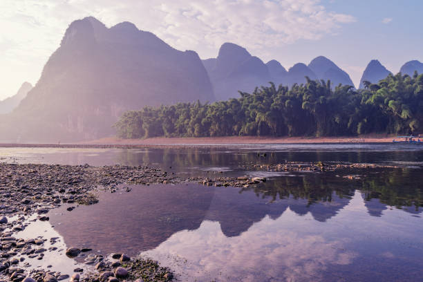 Sunrise view of karst hills by Li River. Yangshuo. Guangxi Province. Sunrise view of karst hills by Li River. Yangshuo. Guangxi Province. China. guilin hills stock pictures, royalty-free photos & images