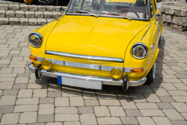 Old yellow retro car's door. Closeup of yellow classic vintage car.