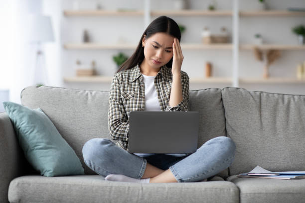 istock Puzzled korean lady freelancer staring at laptop screen 1331266992