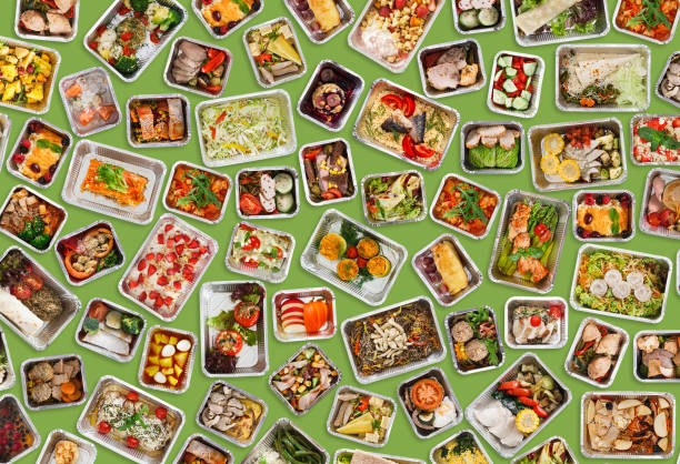 istock Prepared Everyday Meals In Foil Take Away Containers Over Green Background 1331269487