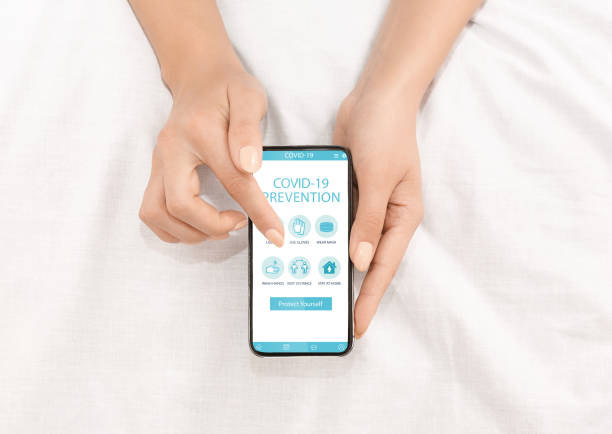 istock Woman showing smartphone with covid preventive measures 1331269562