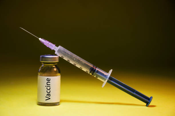 istock Coronavirus Covid-19 vaccine with syringe isolated on Dark background 1331269925