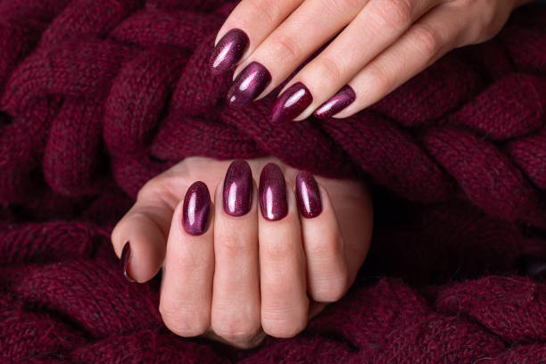 istock Female hand with wine red manicure nails 1331270704