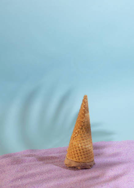 istock ice cream upside down on a sandy background with sunny summer shadows 1331271235