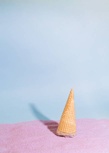 istock ice cream upside down on the violet purple sandy background.abstract sunny idea 1331271257