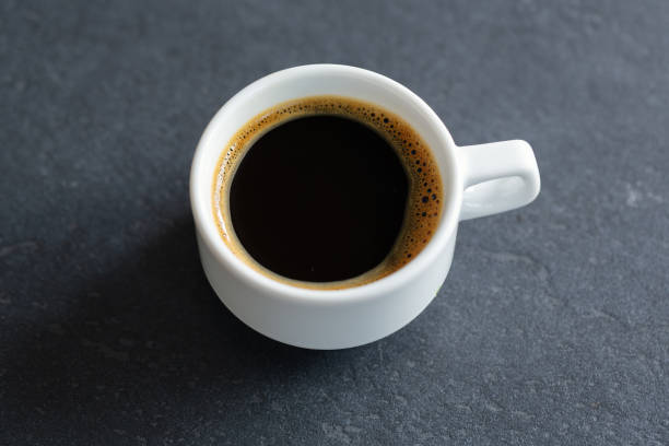 istock Tasty steaming espresso in cup with coffee beans 1331272065