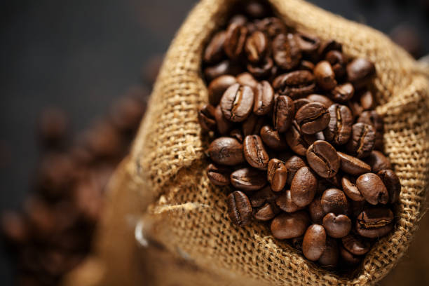 istock Coffee beans espresso closeup in jute sack bag. 1331272086