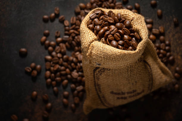 istock Coffee beans espresso closeup in jute sack bag. 1331272102