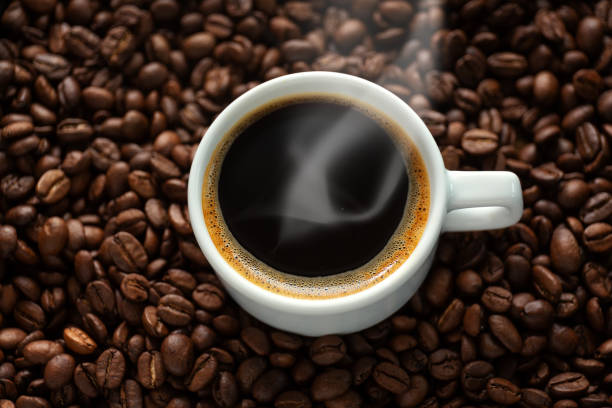 istock Tasty steaming espresso in cup with coffee beans 1331272133
