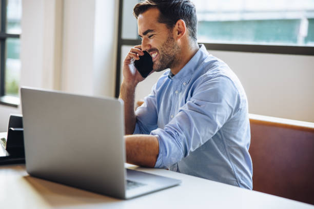 istock Cheerful businessman talking with client on cell phone 1331272361