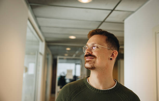 istock Male executive looking away in office 1331272466