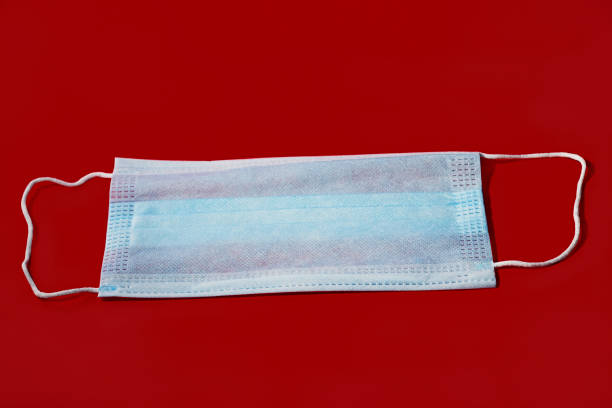 istock Surgical mask on Red background 1331272563